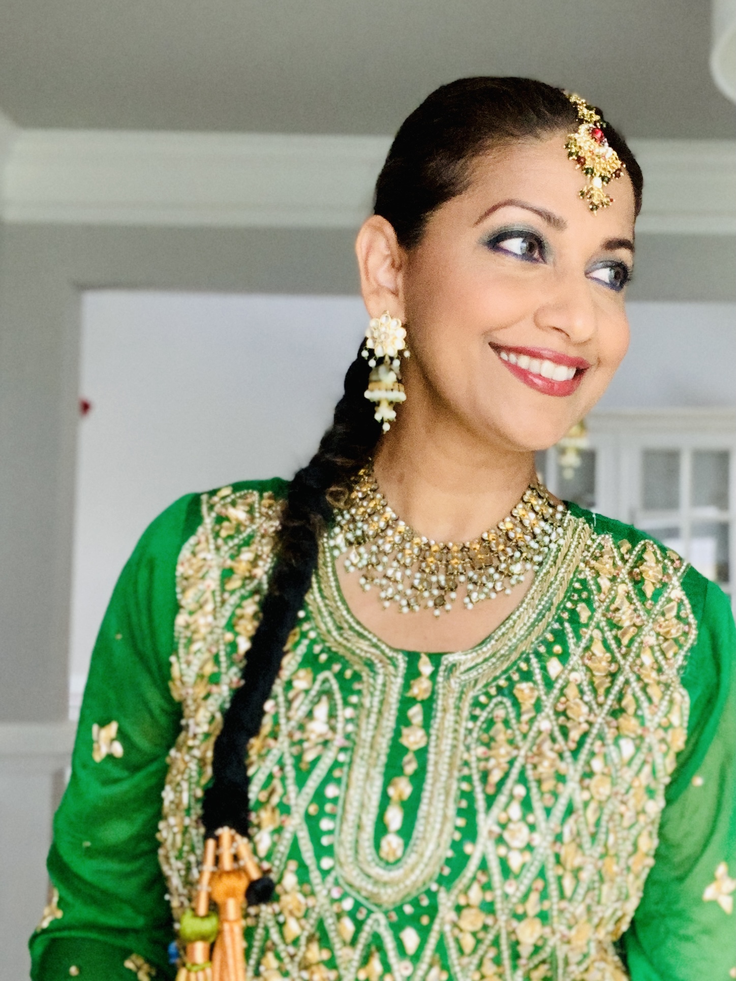 Sanam Azeem in green embroidered dress with traditional jewelry